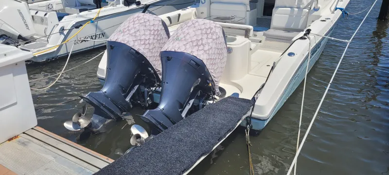 Dos Suenos Yacht Photos Pics Century 30 boat, 2015 model, docked with dual outboard motors, covered in protective fabric.