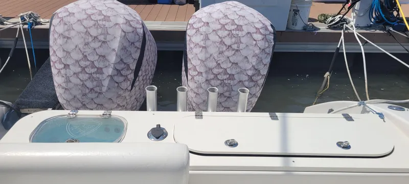 Dos Suenos Yacht Photos Pics Century 30 boat, 2015 model, with covered engines docked at a marina.