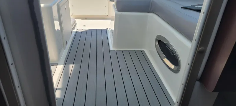 Dos Suenos Yacht Photos Pics Interior view of a 2015 Century 30 boat with sleek seating and modern flooring.