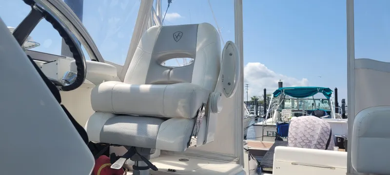 Dos Suenos Yacht Photos Pics Captain's chair on a 2015 Century 30 boat, docked under a clear blue sky.