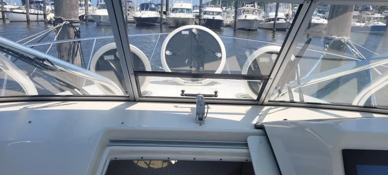 Dos Suenos Yacht Photos Pics 2015 Century 30 boat interior with marina view, featuring a sleek dashboard and windshield.