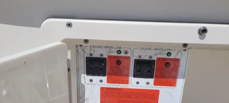 Dos Suenos Yacht Photos Pics Electrical panel with warning labels on a 2015 Century 30 boat.