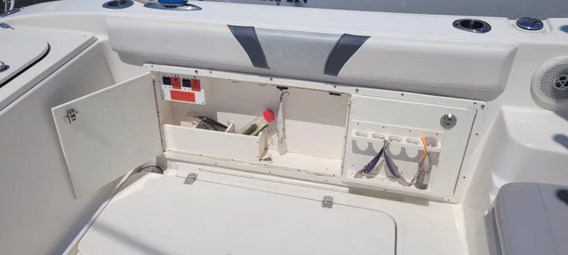 Dos Suenos Yacht Photos Pics Storage compartment on a 2015 Century 30 boat, featuring tools and accessories.