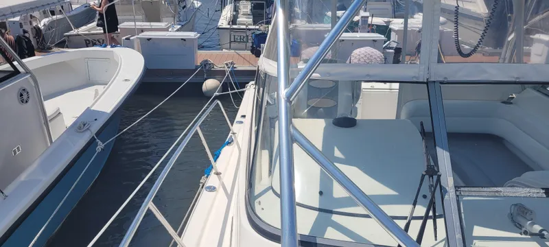 Dos Suenos Yacht Photos Pics Two boats docked side by side, featuring a 2015 Century 30 model.