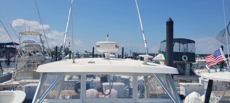 Dos Suenos Yacht Photos Pics 2015 Century 30 boat docked at marina, surrounded by other vessels, clear sky above.