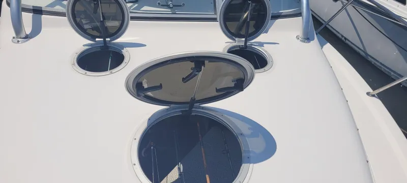 Dos Suenos Yacht Photos Pics 2015 Century 30 boat deck with open hatches and railings.