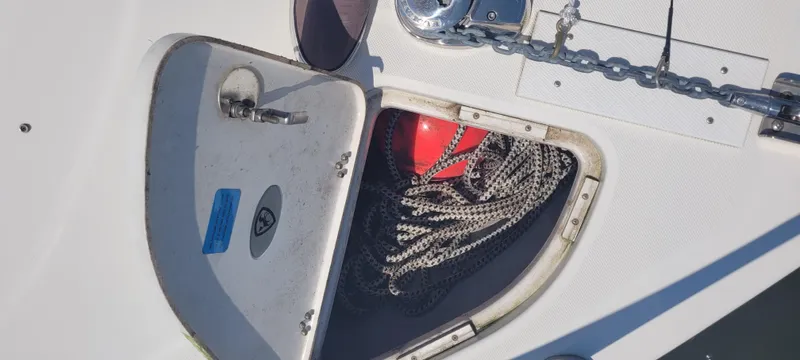 Dos Suenos Yacht Photos Pics Open storage compartment on 2015 Century 30 boat with rope and red buoy.