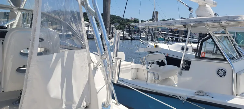 Dos Suenos Yacht Photos Pics Century 30 boat, 2015 model, docked at marina with clear skies and surrounding vessels.