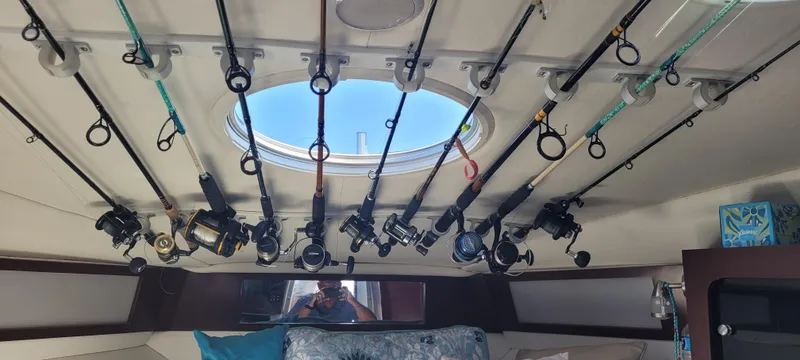 Dos Suenos Yacht Photos Pics Interior of a 2015 Century 30 boat with fishing rods stored on the ceiling.