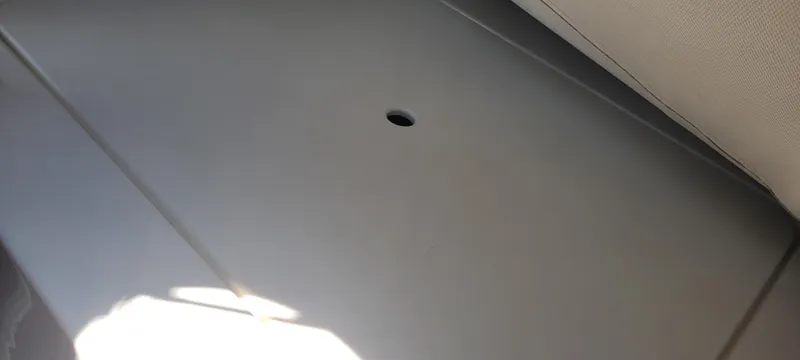 Dos Suenos Yacht Photos Pics Interior view of a 2015 Century 30 boat, featuring a smooth, gray surface with a small hole.