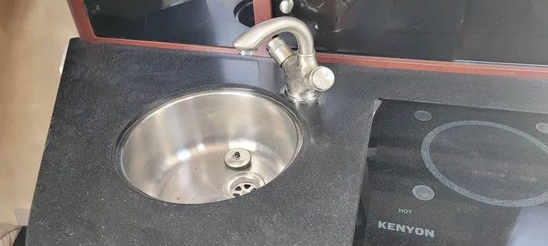 Dos Suenos Yacht Photos Pics Compact kitchen sink and Kenyon cooktop in a 2015 Century 30 model.