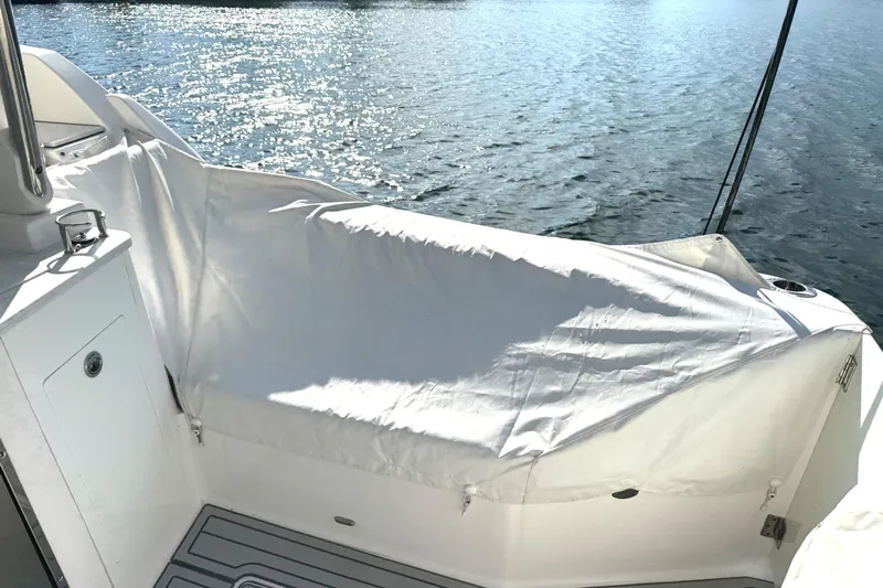  Yacht Photos Pics 2020 Regal 33 SAV boat deck with protective cover on a sunny day.