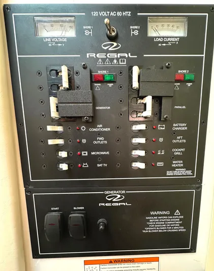 Yacht Photos Pics Control panel of a 2020 Regal 33 SAV boat, showing electrical switches and meters.
