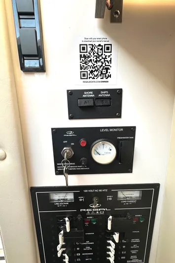  Yacht Photos Pics Control panel of a 2020 Regal 33 SAV boat with switches and a QR code.