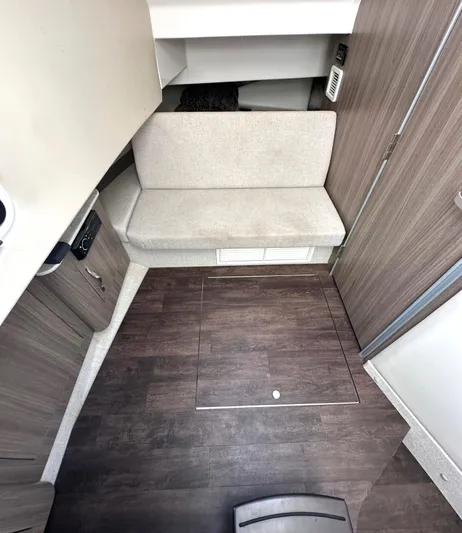 Yacht Photos Pics 2020 Regal 33 SAV interior with wood flooring and cushioned seating.