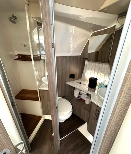 Yacht Photos Pics 2020 Regal 33 SAV boat bathroom with modern wood accents and compact design.