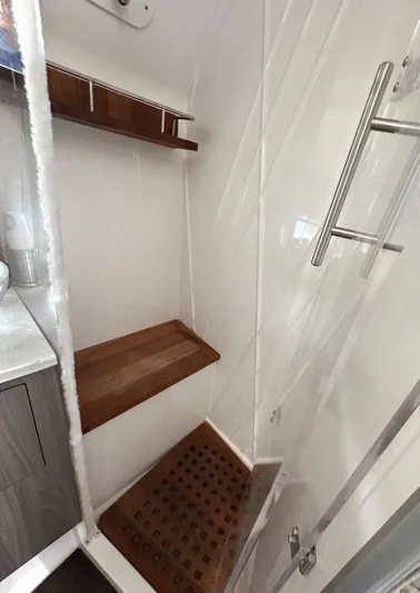  Yacht Photos Pics 2020 Regal 33 SAV interior shower with wooden shelves and modern fixtures.