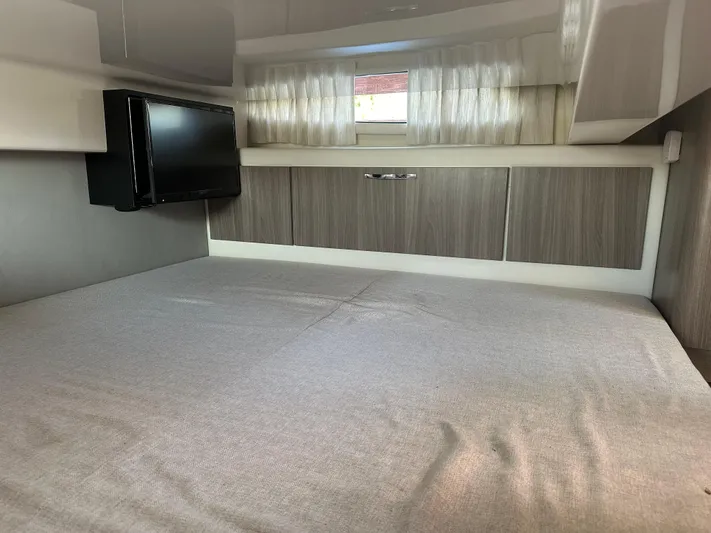  Yacht Photos Pics Interior cabin of 2020 Regal 33 SAV boat with bed and TV.