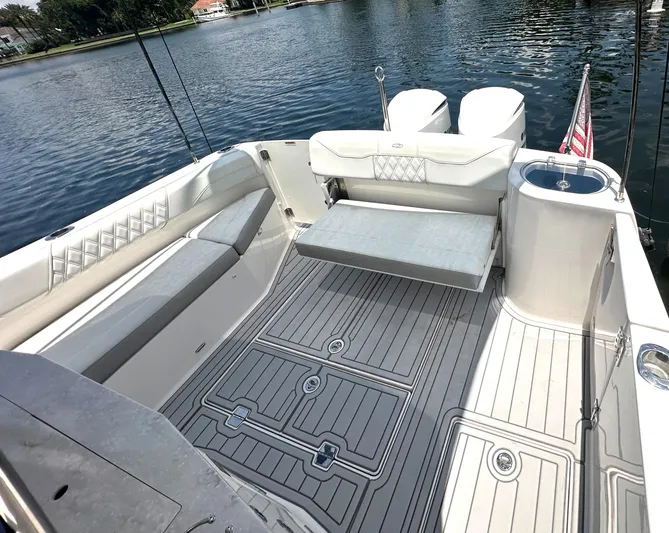  Yacht Photos Pics 2020 Regal 33 SAV boat interior with seating and deck, on a calm lake.