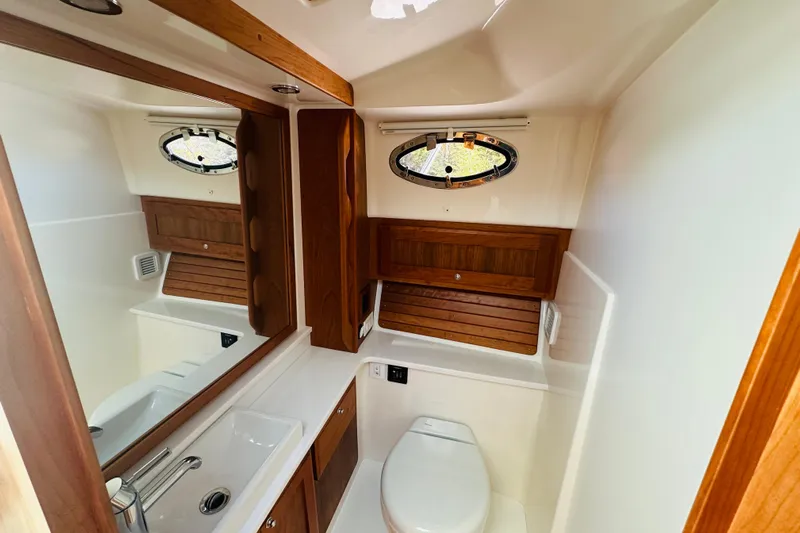 Amanda Yacht Photos Pics 2024 Back Cove 34O yacht bathroom with wooden accents and modern fixtures.