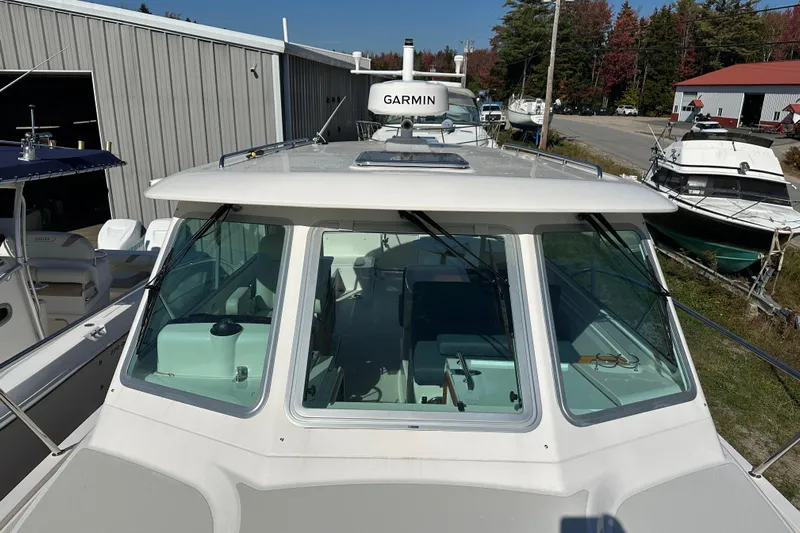 Amanda Yacht Photos Pics 2024 Back Cove 34O boat with Garmin equipment, docked near a storage facility.