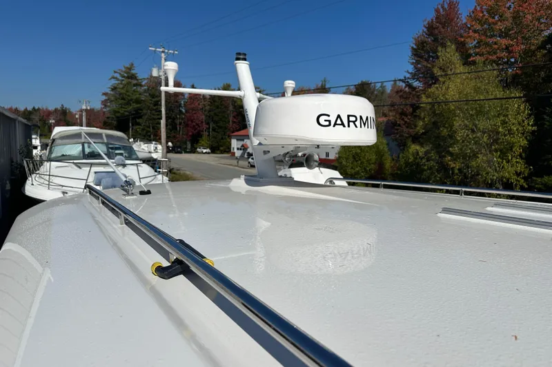 Amanda Yacht Photos Pics 2024 Back Cove 34O boat with Garmin radar, docked under clear blue sky.