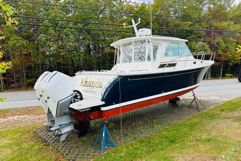 Amanda Yacht Photos Pics 2024 Back Cove 34O boat on display, featuring dual outboard engines, parked roadside.