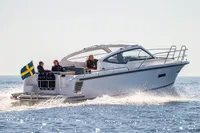 2026 Nimbus 305 Drophead cruising on open water with passengers, Swedish flag visible.
