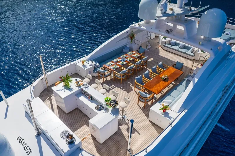 Oceanos Yacht Photos Pics Luxurious 2006 Mondomarine motor yacht with elegant outdoor dining and lounge area.