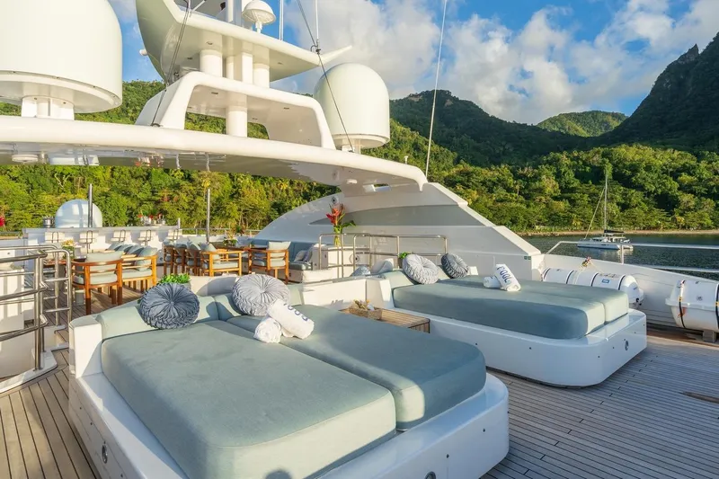 Oceanos Yacht Photos Pics Luxurious 2006 Mondomarine motor yacht deck with sun loungers and scenic mountain view.