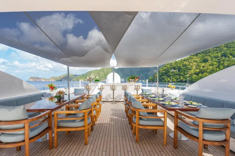 Oceanos Yacht Photos Pics Luxurious 2006 Mondomarine motor yacht deck with elegant dining setup and scenic ocean view.