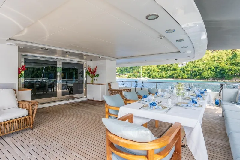Oceanos Yacht Photos Pics Luxurious Mondomarine 2006 motor yacht deck with elegant dining setup and scenic water view.