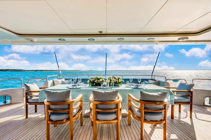 Oceanos Yacht Photos Pics Luxurious dining setup on a 2006 Mondomarine motor yacht, overlooking serene ocean views.