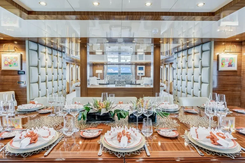 Oceanos Yacht Photos Pics Luxurious dining area on a 2006 Mondomarine motor yacht, elegantly set table with modern decor.