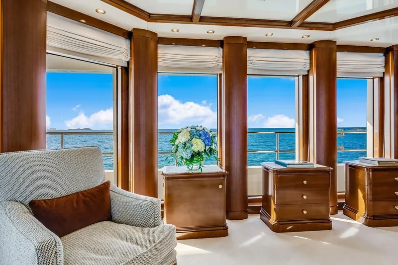 Oceanos Yacht Photos Pics Luxurious Mondomarine motor yacht interior with ocean view, featuring elegant wood paneling and plush seating.