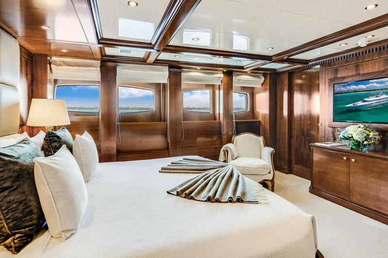Oceanos Yacht Photos Pics Luxurious Mondomarine 2006 motor yacht bedroom with elegant wood paneling and ocean views.