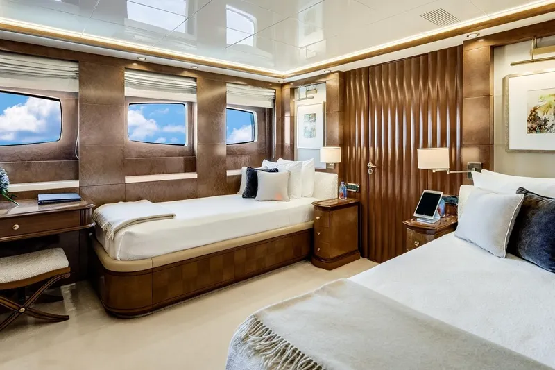 Oceanos Yacht Photos Pics Luxurious Mondomarine 2006 motor yacht bedroom with elegant wood paneling and twin beds.