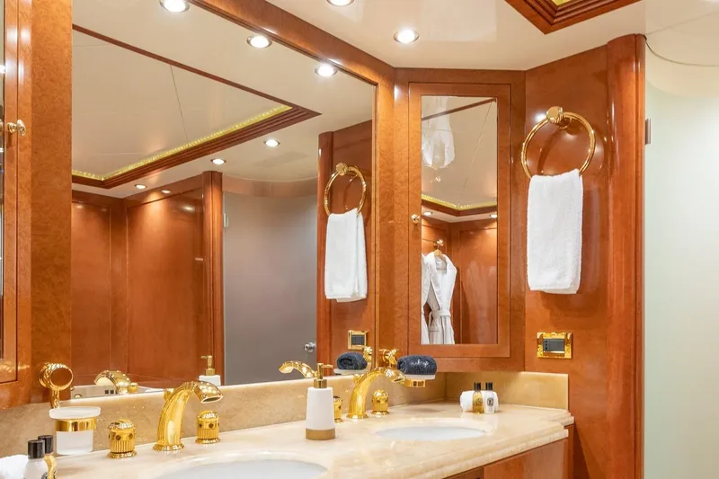 Oceanos Yacht Photos Pics Luxurious bathroom on 2006 Mondomarine motor yacht with elegant wood and gold accents.
