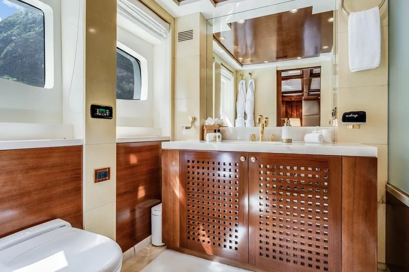 Oceanos Yacht Photos Pics Luxurious bathroom on a 2006 Mondomarine motor yacht with elegant wood and gold accents.
