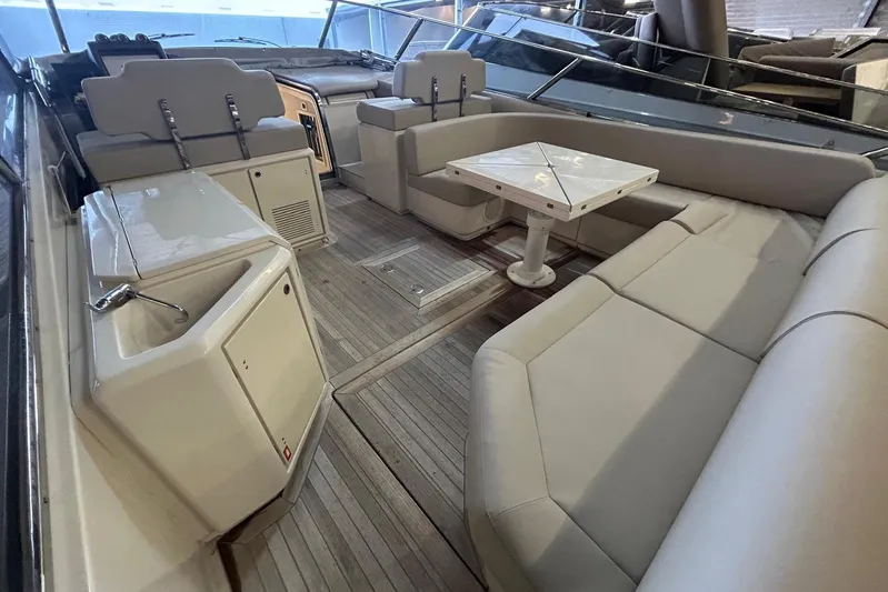  Yacht Photos Pics Luxurious interior of 2020 Itama 62 yacht with elegant seating and table.