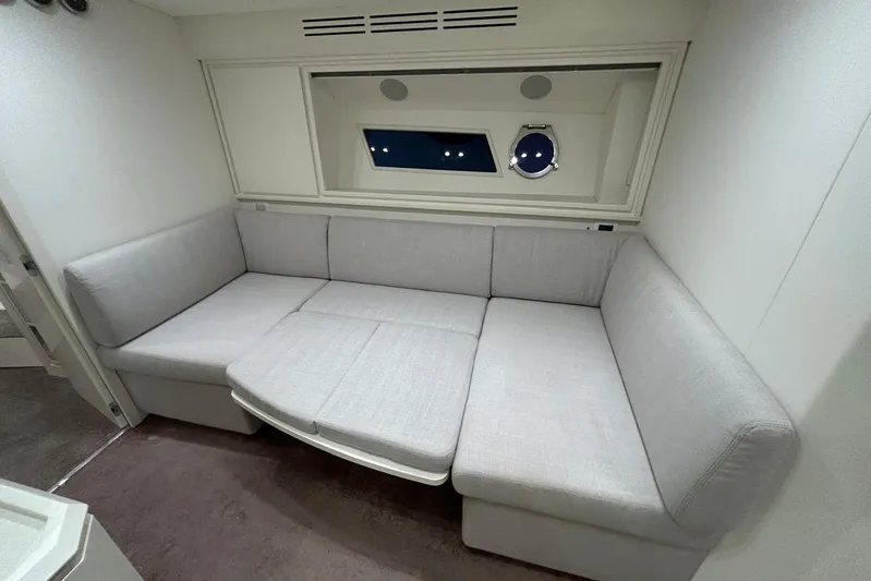  Yacht Photos Pics Modern interior of 2020 Itama 62 yacht with gray L-shaped sofa.