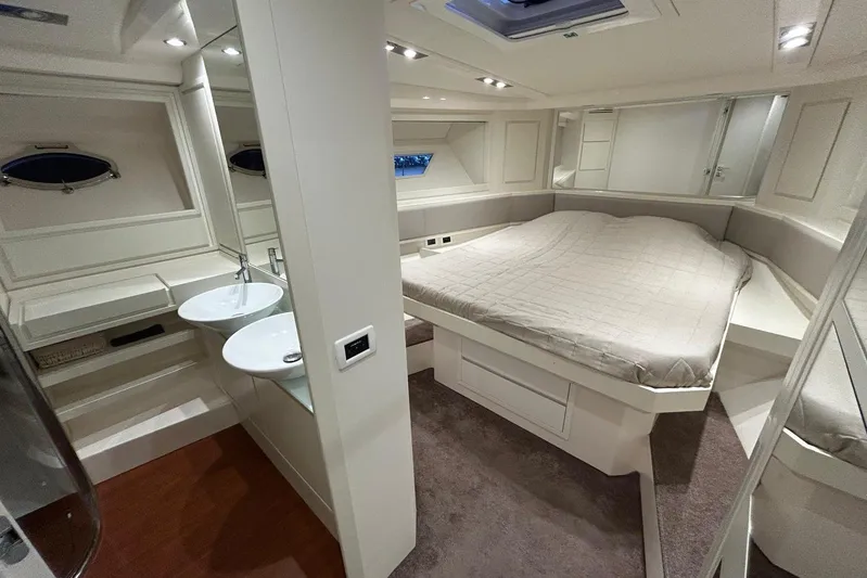  Yacht Photos Pics Luxurious interior of 2020 Itama 62 yacht featuring a spacious bedroom and modern bathroom.