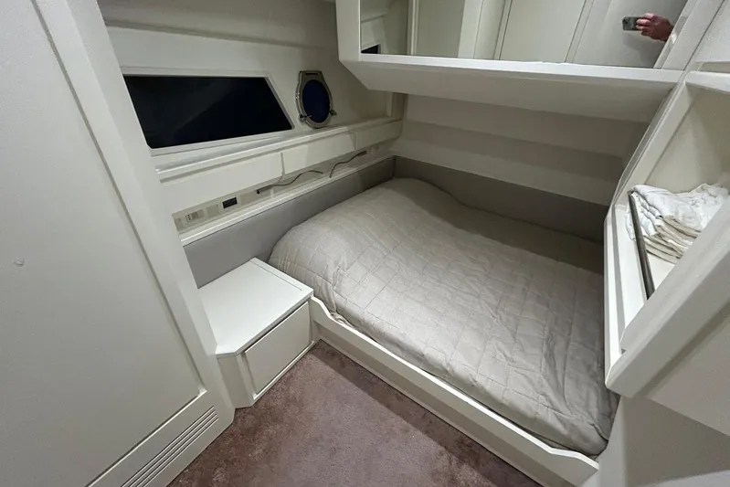  Yacht Photos Pics Cozy cabin interior of 2020 Itama 62 yacht with bed and storage.
