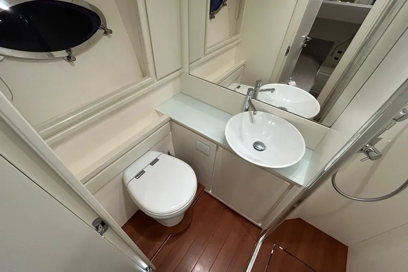  Yacht Photos Pics Luxurious bathroom in 2020 Itama 62 yacht with modern fixtures and wooden flooring.