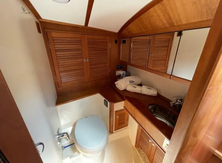Better By Far Yacht Photos Pics Luxurious 2012 Hinckley Talaria yacht bathroom with wooden cabinetry and modern fixtures.
