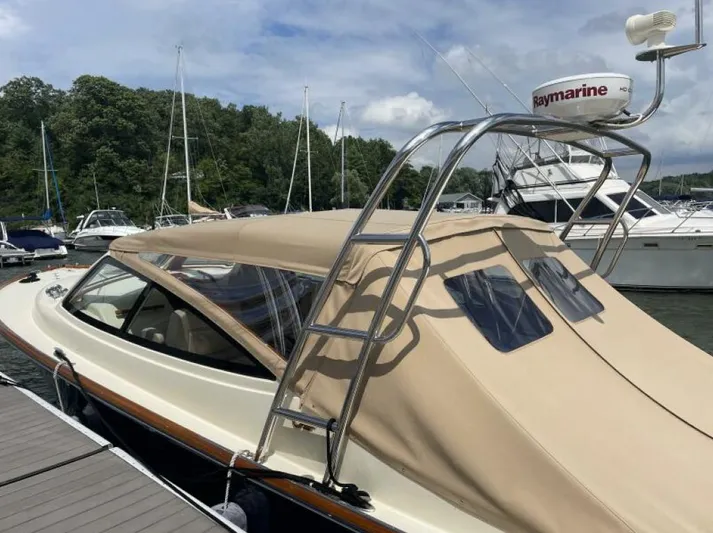 Better By Far Yacht Photos Pics 2012 Hinckley Talaria yacht docked, featuring beige canopy and Raymarine radar.