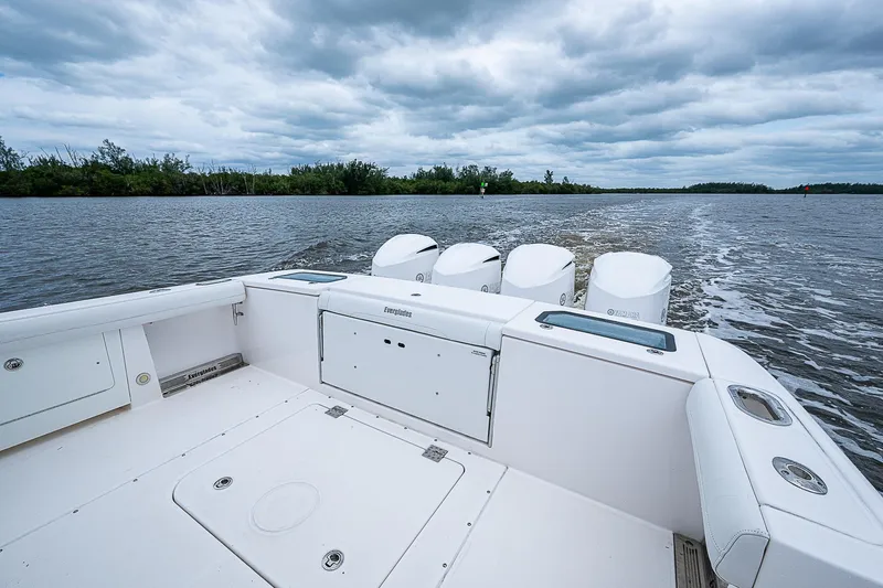 Riptide Yacht Photos Pics 2018 Everglades 435 Center Console boat on a calm lake under cloudy skies.