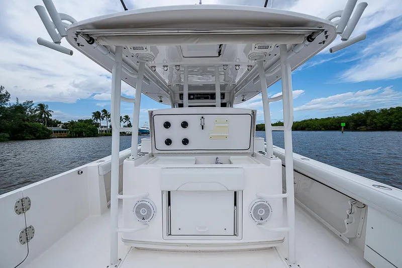 Riptide Yacht Photos Pics 2018 Everglades 435 Center Console boat on a serene waterway, showcasing its spacious deck.