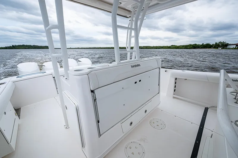Riptide Yacht Photos Pics 2018 Everglades 435 Center Console boat on water, showcasing spacious deck and seating.
