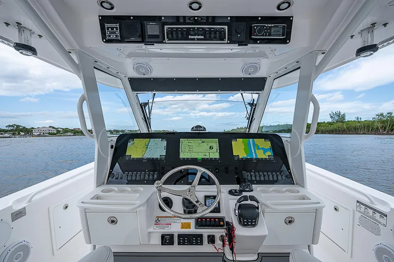Riptide Yacht Photos Pics 2018 Everglades 435 Center Console boat dashboard with navigation screens and steering wheel.